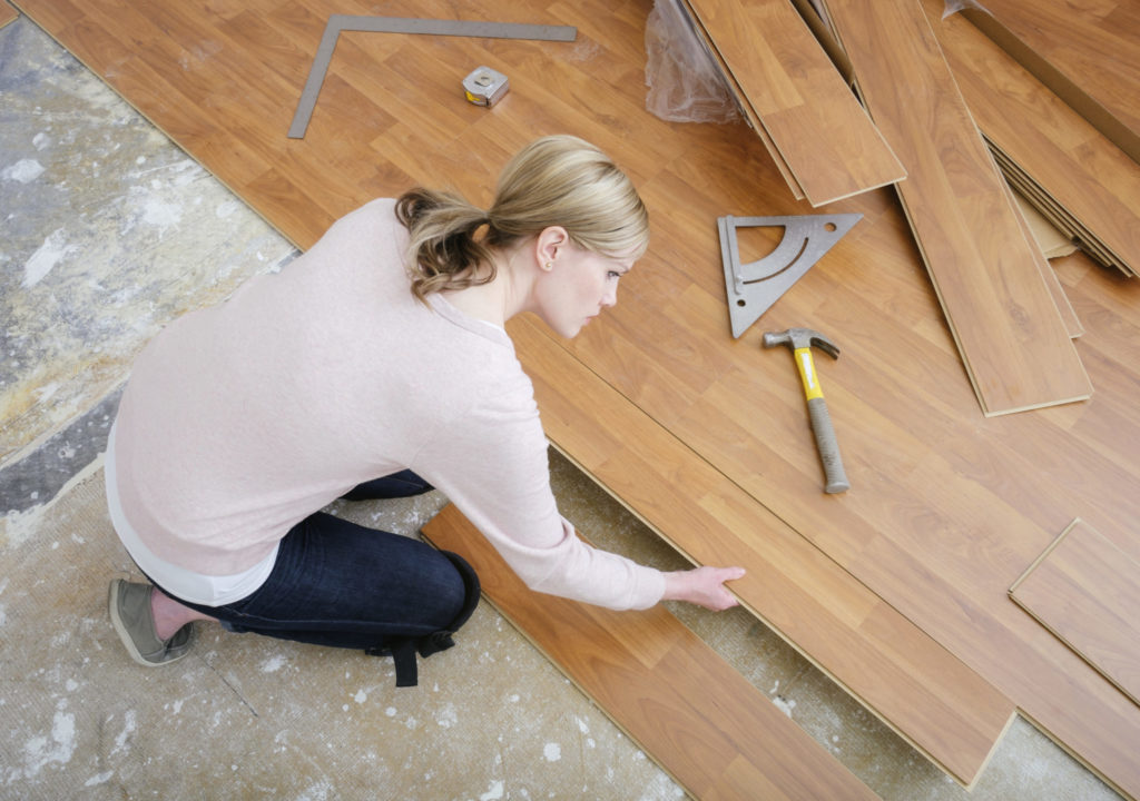 Woman Installing Laminate Flooring